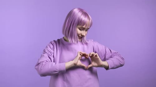 Teenage Girl Making Heart Shape With Hands