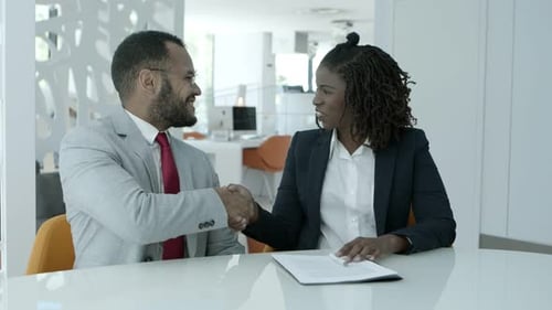 Business Meeting With Document Review and Handshake