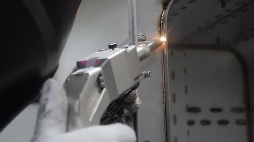 Welder Using Welding Machine Sparks in Workplace