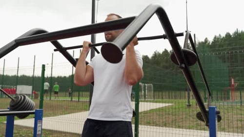 Man is Engaged in a Simulator on a Sports Field in the Park