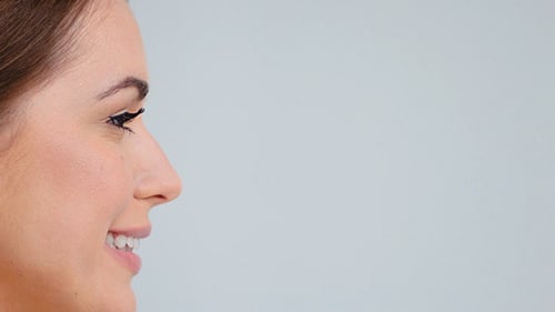 Side View on Beautiful Woman Face Posing Over Gray