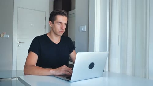 Man Working on Laptop at Home Office