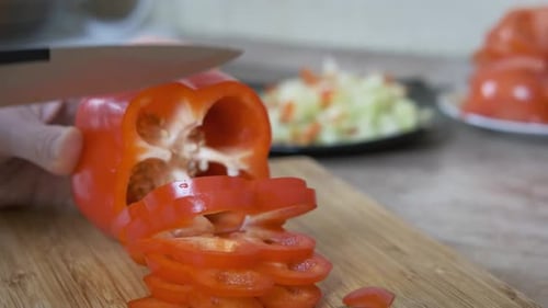 Slicing a Red Bell Pepper on Cutting Board