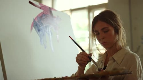 Woman Artist Painting an Abstract in Studio