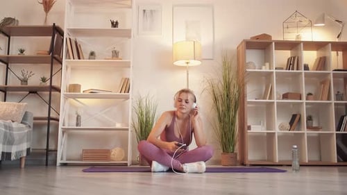Energetic Woman Dancing with Headphones at Home