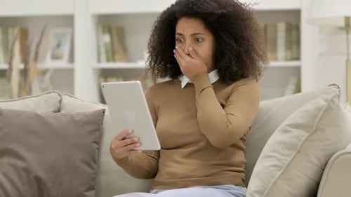 Loss Young African Woman Reacting to Failure on Sofa