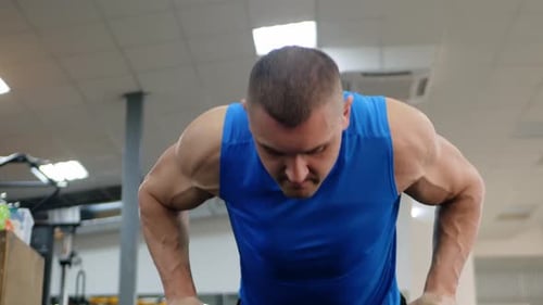 Muscular Trainer in the Gym is Engaged in Sports