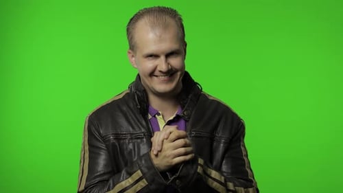 Rocker Man in Brown Denim Jacket Rubbing Hands and Plotting Cunning Idea, Planning Prank