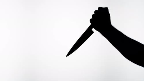 Man Holding Knife Closeup Shadow Silhouette of Hand with Weapon
