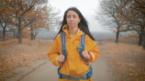 Woman Traveler with Backpack Walking in the Mountains, Freedom and Happiness. Active Sport Lifestyle