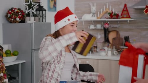 Teen Girl Receives Christmas Gifts From Senior Woman