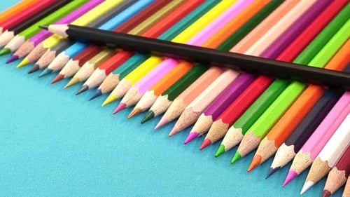 Assorted Colorful Pencils on Bright Blue Surface