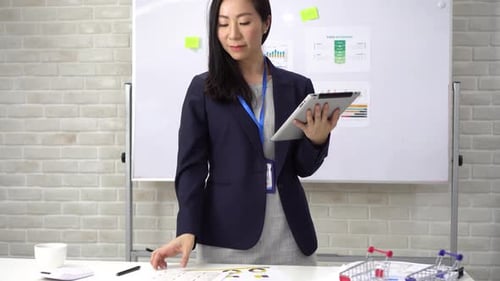 Business Woman Checking Financial and Account Documents at Office