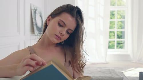 Young Woman Reading a Book Indoors