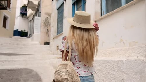 Beautiful Girl Tourist Walking in the Streets of Poros City Greece