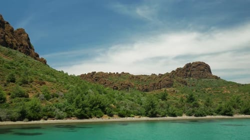 Swim to the green hills and watch the volcanic cliffs