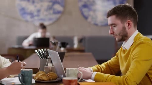 Adults working at a cafe