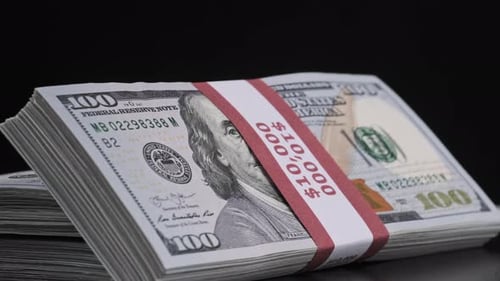 Stacks of Money with Dollar Bills on Black