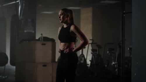 Athletic Woman Resting After Workout in Gym