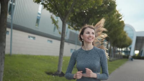 Young Woman Runner Training in Summer Park City