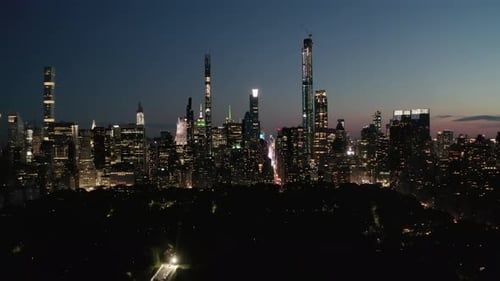 AERIAL: Time Lapse Hyper Lapse Over New York City Central Park at Night with Skyline View