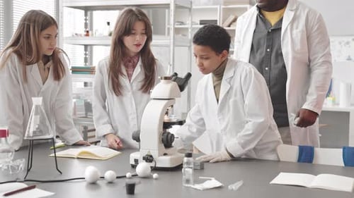 Students Studying Science with Microscope in Lab Classroom