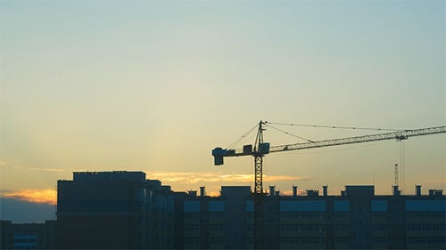 Construction Crane Silhouetted Against Evening Sky