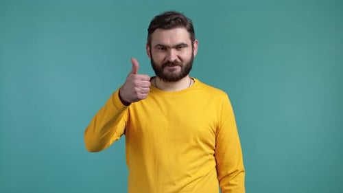 Bearded Man Gives Thumbs Up on Blue Background