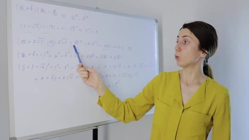 Woman Explaining Math Equations on Whiteboard