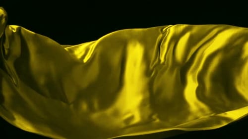 Abstract Yellow Cloth Gently Flowing on Black