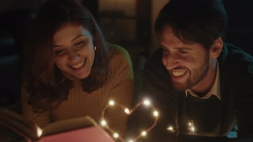 Loving Couple Reading Book Together at Night