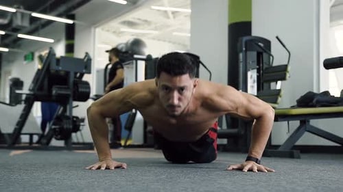 Caucasian Man Doing Push Ups in the Gym