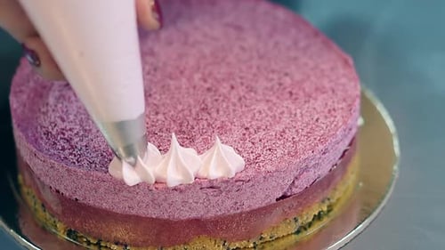Woman Gradually Decorates Pink Biscuit Cake Top with Cream