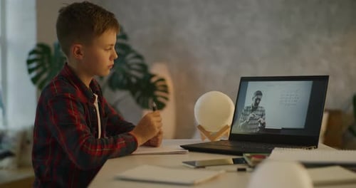 Young Boy Learning Math Online at Home
