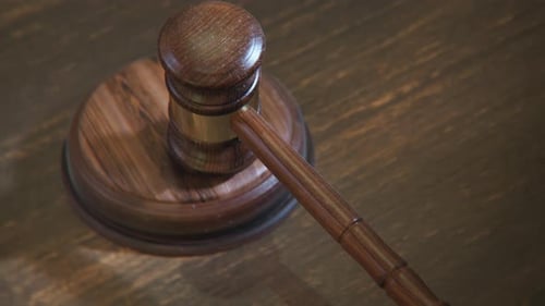 Gavel hitting sound block in court of law. Symbol of justice, judge, authority