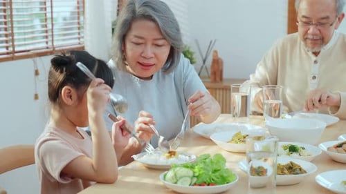 Family Eating Meal Together at Home Dining Table