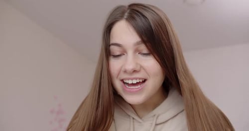 Woman with Long Brown Hair Smiling Indoors
