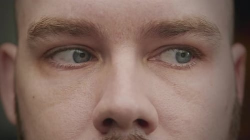 Close Up Shot of Caucasian Adult Man Blue Eyes Looking From Side to Side
