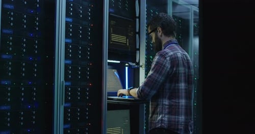 Bearded IT Specialist Setting Servers in Data Center