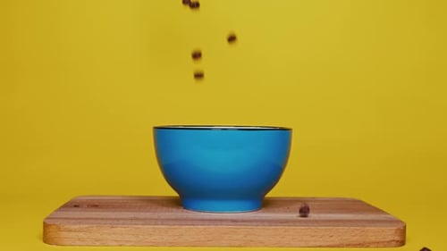 Breakfast Cereal Pieces Falling Into Blue Bowl