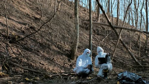 Forensic specialists working in the forest. Crime scene and police concept.