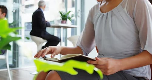 Businesswoman Reading in Modern Office