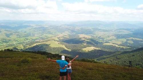 Tourist in love enjoys the mountain views.