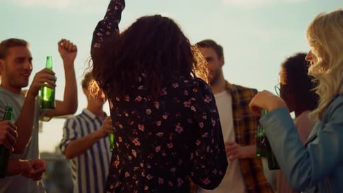 Friends Celebrating on Rooftop During Golden Hour