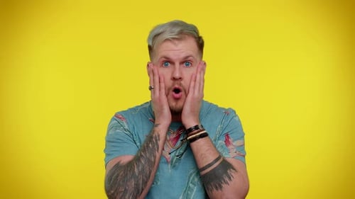 Man Reacting with Shock on Yellow Background