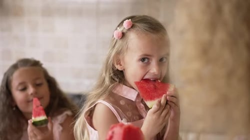 Children Enjoying Juicy Watermelon Slices Indoors