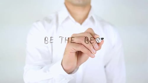 Man Writes 'Be the Best' on Clear Surface