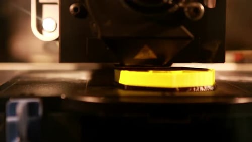 3D Printer Creates Yellow Object in Close Up