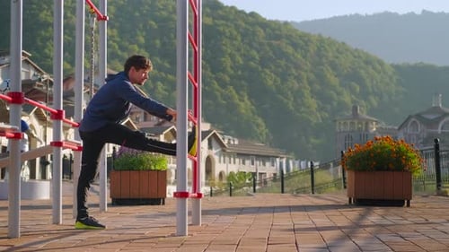 Sporty Man Doing Legs Stretching Exercise Outdoors