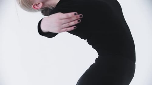 Young Beautiful Blonde Woman Ballerina Training in the Studio Bending Her Back Backwards